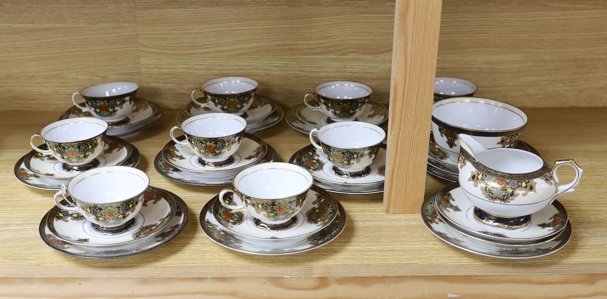 A Japanese Noritake floral and gilt tea set, comprising a sugar bowl, a milk jug, nine cups, plus saucers and tea plates